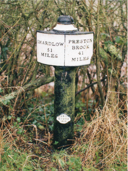 Figure 5. - Milepost punctuating the run of the Trent and Mersey Canal, humanizing this transport link and embedding it into the existing landscape. Photo by Milestone Society Sshu94 CC-BY-SA 2.0.